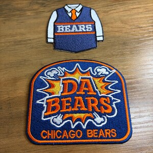 May include: Two embroidered patches featuring Chicago Bears designs. One patch is shaped like a vest with the word "BEARS" and the other patch has the words "DA BEARS" and "CHICAGO BEARS" in orange and white on a blue background.