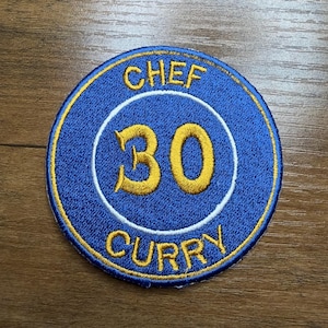 May include: Embroidered patch with a blue background and a gold border. The patch features the words "CHEF" and "CURRY" in gold, with the number "30" in gold inside a white circle.