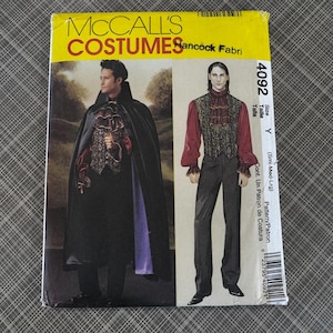 May include: A McCall's Costumes pattern envelope featuring two costume designs. One design shows a person in a black cape and vest. The other design shows a person in a red shirt and vest. The envelope is yellow with the text "MCCALL'S COSTUMES".
