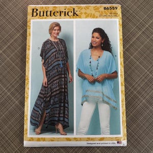 May include: A Butterick sewing pattern package featuring two women modeling clothing. The package includes the text "Butterick" and "B6559". The models are wearing a long patterned dress and a blue top with white pants.