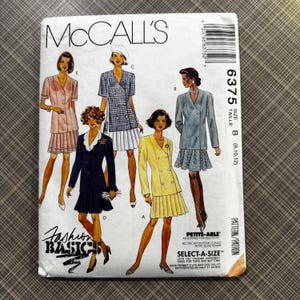May include: McCall's sewing pattern featuring illustrations of women's suits. The pattern cover displays various suit designs in colors like pink, blue, and yellow. Text includes "Fashion Basics" and "Select-A-Size".