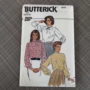 May include: A vintage Butterick sewing pattern, size 14-16-18, featuring illustrations of blouses. The pattern cover is white with the Butterick logo and the words "Fast & Easy". The blouses are in white, pink, and yellow.