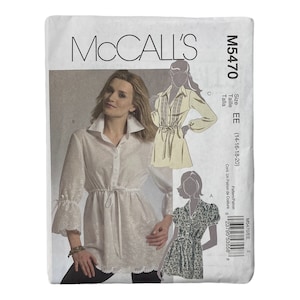 May include: McCall's sewing pattern M5470 for sizes EE (14-16-18-20). The pattern includes instructions for making a white blouse with a tie waist and a lace trim, a yellow blouse with a tie waist, and a floral print blouse with a tie waist.