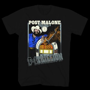May include: A black t-shirt featuring a graphic print of Post Malone in a cowboy hat and blue shirt, a brown horse, a jukebox, and a clock. The text POST MALONE appears at the top, and the text F-1 TRILLION is printed in a metallic block font below.