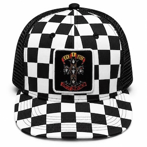 May include: A black and white checkered trucker hat featuring a square patch on the front panel. The patch displays a cross graphic with five skulls and the text Guns N' Roses and Appetite for Destruction in red and yellow lettering on a black background.