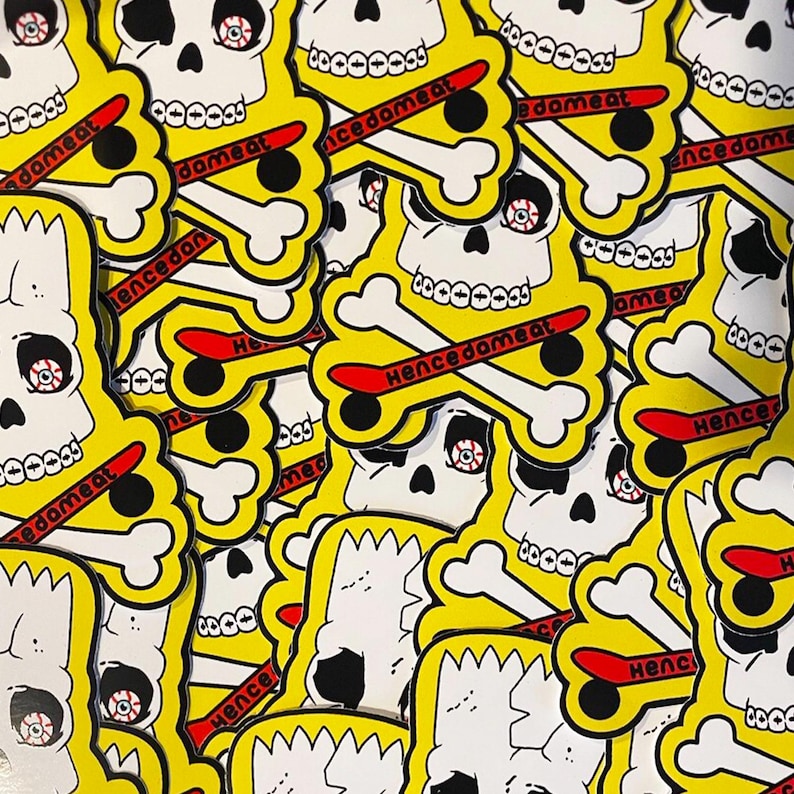 May include: A collection of die-cut stickers featuring a yellow skull with a single bloodshot eye, white teeth, and a red skateboard deck printed with the text "hencedameat" layered over white crossbones on a bright yellow background.