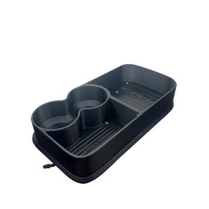 May include: A dark gray automotive center console organizer tray featuring two circular cup holders and a rectangular storage compartment. The base of the tray includes embossed text reading MOD N TUNE and CR-V, with a textured ribbed surface design.
