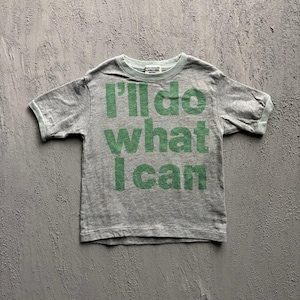 May include: A heather grey short-sleeve t-shirt featuring the green text I'll do what I can printed on the front. The garment has a crew neckline and a standard fit, with a small white brand label visible inside the collar at the back neckline.