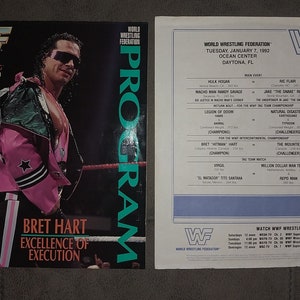May include: A wrestling program and event schedule from the World Wrestling Federation. The program cover features Bret Hart in a pink and black outfit. The schedule lists matches including Hulk Hogan and Ric Flair.
