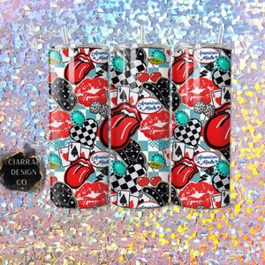 May include: Three stainless steel tumblers with a colourful pattern featuring red lips, playing cards, cherries, and the text "American Made".