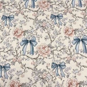 May include: A repeating pattern featuring light blue bows, pink peonies, and delicate white blossoms on a cream background. The design includes stylized branches, creating a vintage floral aesthetic suitable for fabric or wallpaper.