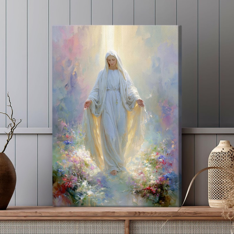 May include: Canvas art print of a serene figure in a flowing white gown, arms outstretched, set against a soft, ethereal backdrop of pastel colors and light. The artwork is surrounded by colorful flowers, creating a peaceful and spiritual scene.