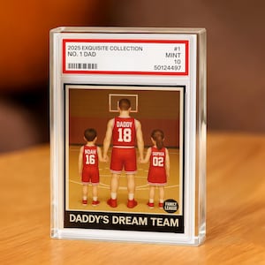 May include: A clear acrylic block featuring a basketball-themed image. The image shows a father and two children in red basketball uniforms. Text includes "2025 EXQUISITE COLLECTION NO. 1 DAD" and "DADDY'S DREAM TEAM".