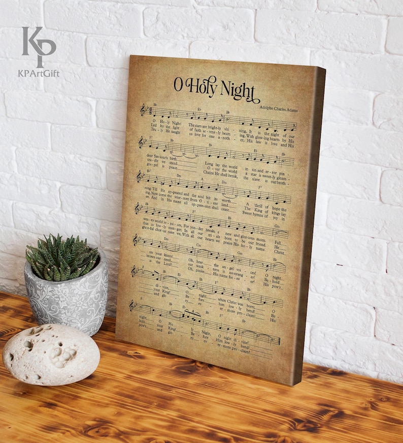 May include: Vintage sheet music print of the Christmas carol "O Holy Night" by Adolphe Adam. The music notes and lyrics are printed on a beige background with a distressed, aged look.