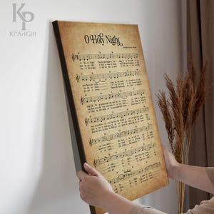May include: Vintage sheet music print of the Christmas carol "O Holy Night" with musical notes and lyrics. The paper has a yellowed, aged look.