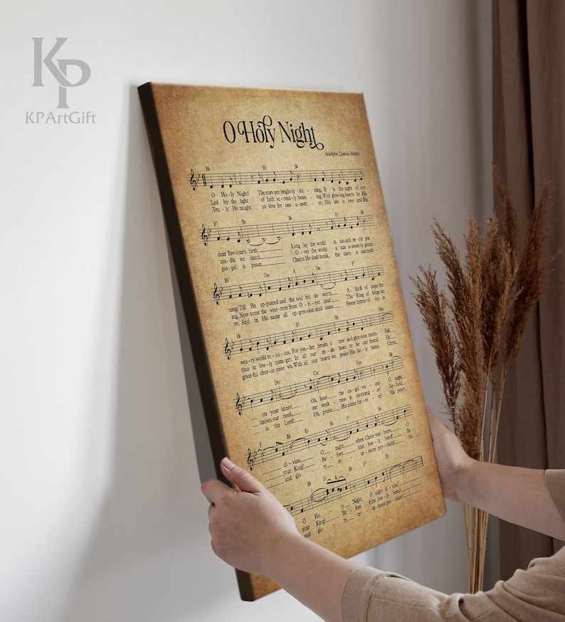 May include: Vintage sheet music print of the Christmas carol "O Holy Night" with musical notes and lyrics. The paper has a yellowed, aged look.