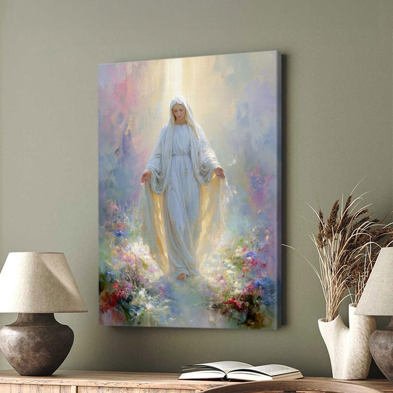 May include: A canvas print depicts a serene figure in a flowing white gown, arms outstretched, bathed in ethereal light. The artwork features soft pastel colors and a floral foreground, creating a peaceful and spiritual ambiance. The image is displayed on a wall.
