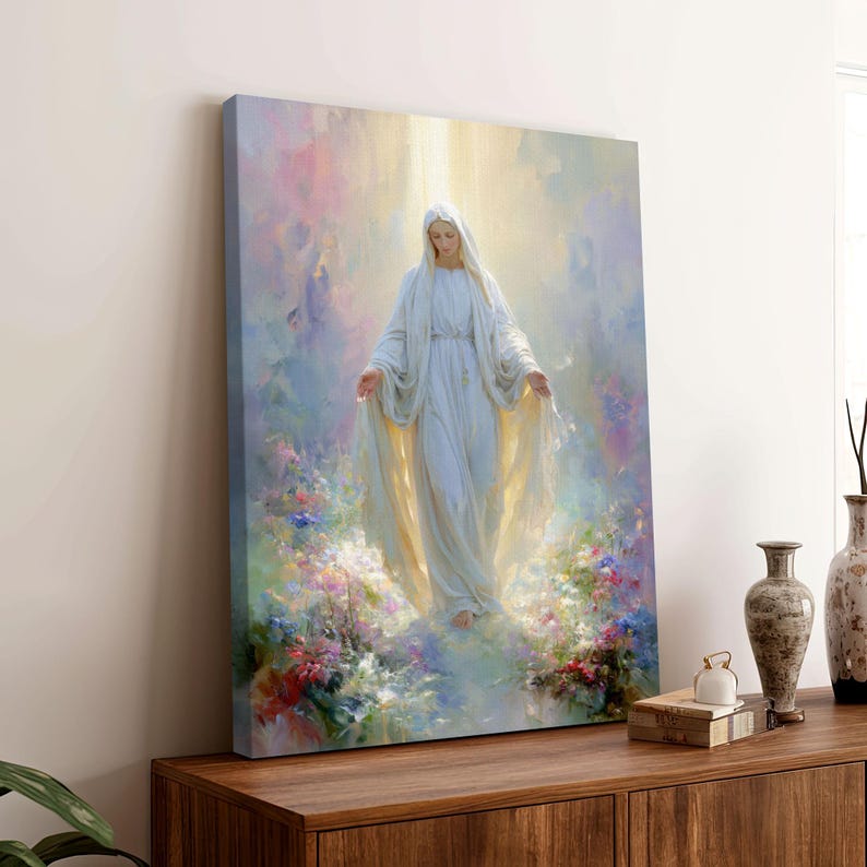 May include: A canvas print of a religious figure in a white gown, surrounded by soft light and colorful flowers. The artwork depicts a serene scene with a sense of peace and spirituality, suitable for home decor.