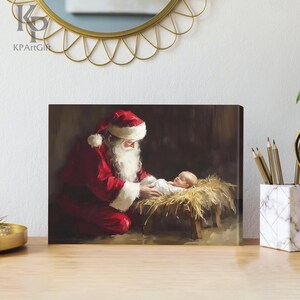 May include: A painting of Santa Claus kneeling beside a baby Jesus in a manger. Santa is wearing a red suit with white trim and a white beard. The baby is lying on a bed of straw and is wearing a white robe.
