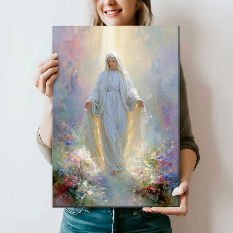 May include: A canvas print featuring a serene depiction of a figure in a flowing white gown, surrounded by soft light and pastel colors. The artwork portrays a spiritual theme, with floral accents at the base, creating a peaceful and ethereal atmosphere.
