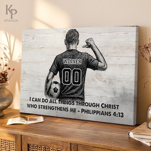 May include: A black and white canvas print featuring a soccer player with the word "WINNER" and the number "00" on the back of their jersey. The text "I CAN DO ALL THINGS THROUGH CHRIST WHO STRENGTHENS ME - PHILIPPIANS 4:13" is also displayed.