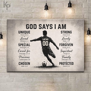 May include: A rectangular canvas print with the text "GOD SAYS I AM" and a soccer player illustration. The player wears a jersey with "LUCAS 00". The print includes words like "UNIQUE", "STRONG", and "CHOSEN", with associated Bible verses.