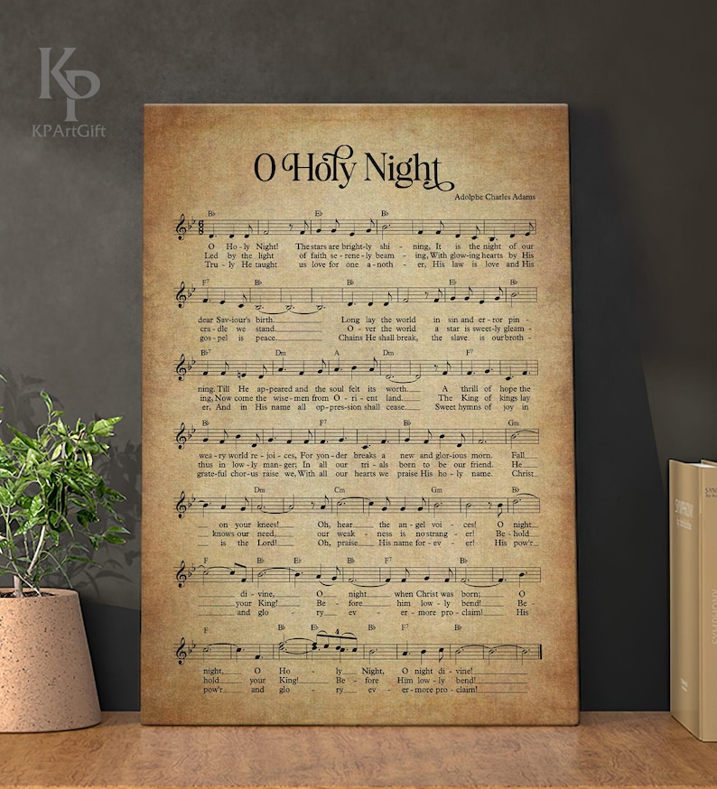May include: A vintage-style print of the Christmas carol "O Holy Night" with sheet music and lyrics. The print features a brown background with faded text and musical notes.