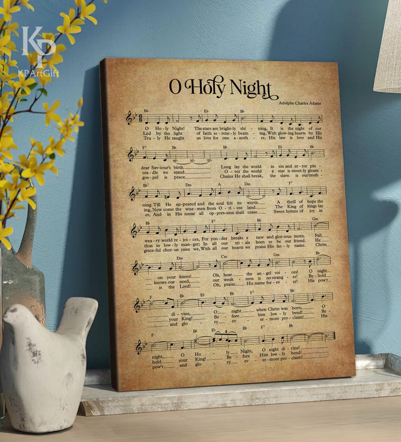 May include: A vintage-style print of the sheet music for the Christmas carol "O Holy Night". The music is printed on a cream-colored background with brown ink. The title "O Holy Night" is printed in large, bold letters at the top of the page. The lyrics and music notes are printed below the title.