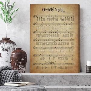 May include: A vintage-style print of the song "O Holy Night" with sheet music and lyrics. The paper is a light brown color with a distressed look. The title is in large, bold letters at the top of the page.