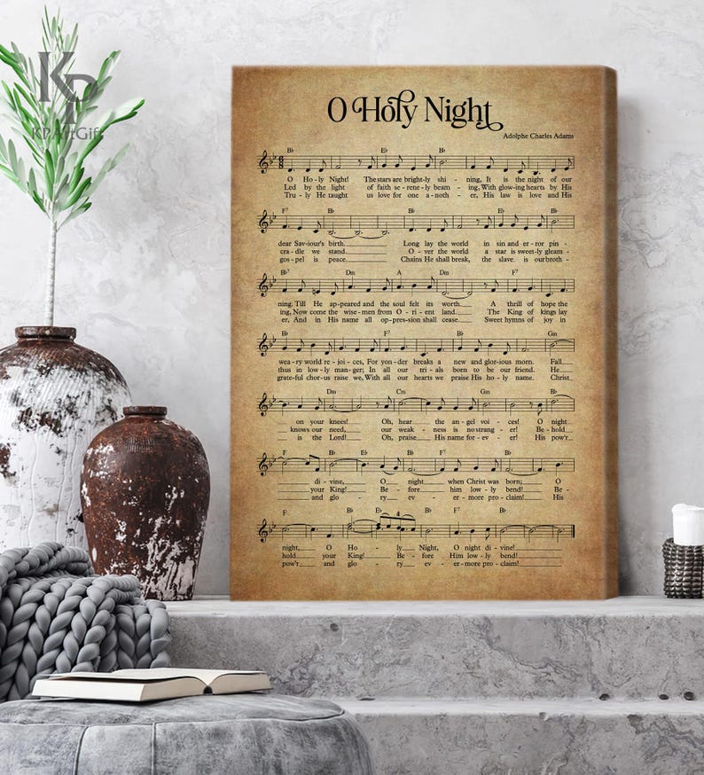 May include: A vintage-style print of the song "O Holy Night" with sheet music and lyrics. The paper is a light brown color with a distressed look. The title is in large, bold letters at the top of the page.