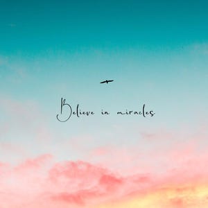 May include: A pink and blue sky with a single bird flying across the frame. The text "Believe in miracles" is written in black cursive script.