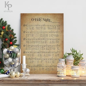 May include: A vintage-style print of the Christmas carol "O Holy Night" with sheet music and lyrics. The print is on a brown background with a distressed look. The title is in large, bold letters at the top of the page.
