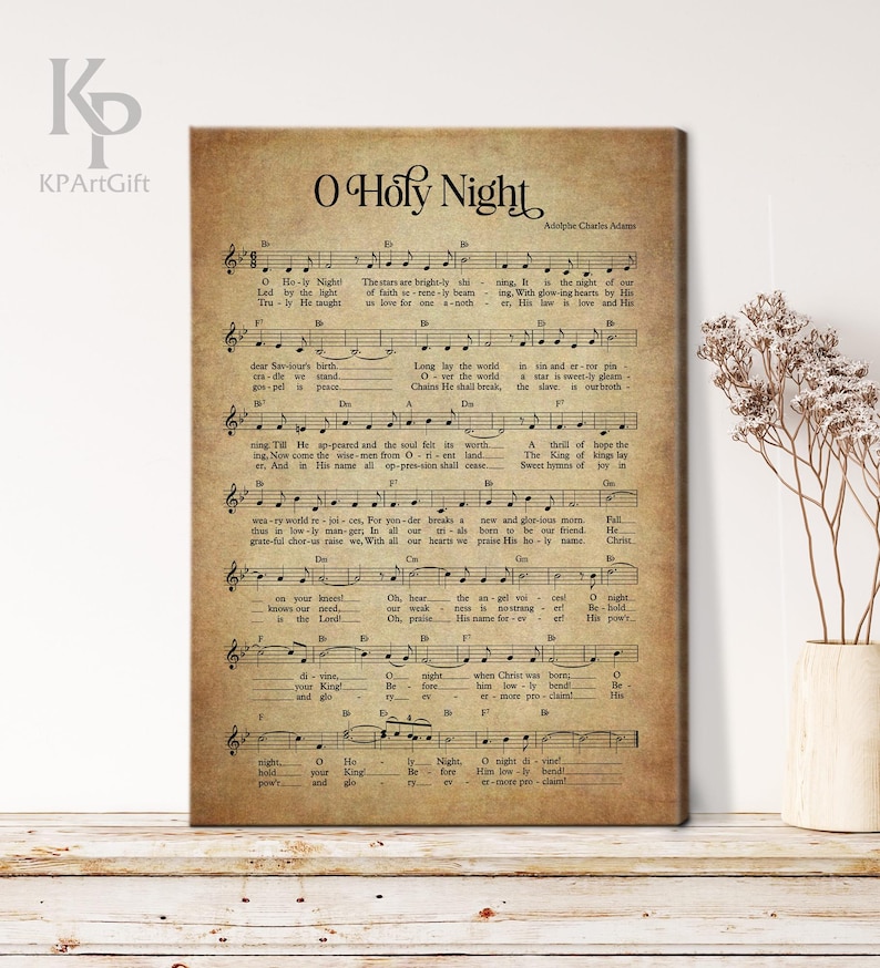 May include: A vintage-style sheet music print of the Christmas carol "O Holy Night". The sheet music is printed on aged paper with a brown background and features the lyrics and musical notation for the song.