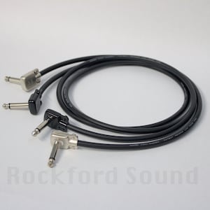 May include: Three black 1/4 inch audio cables with right angle plugs. The cables are coiled and the plugs are silver.