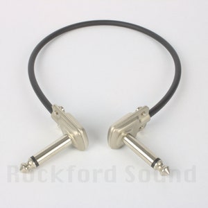 May include: A black 6-inch right-angle guitar patch cable with nickel-plated connectors.