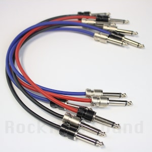 May include: Four guitar patch cables with black, red, blue, and black colored jackets. The cables have 1/4 inch mono plugs on each end.