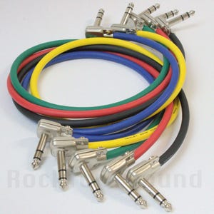 May include: A collection of multi-colored instrument cables with right-angle connectors. The cables are in various colors, including red, yellow, green, blue, and black. The connectors are silver-colored and angled at 90 degrees.