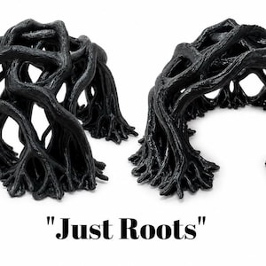 May include: Two black, arch-shaped structures resembling tangled tree roots with a textured, organic surface. The objects are displayed side-by-side, and the text "Just Roots" is printed in black below the items on a plain white background.