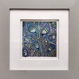 May include: A framed abstract art print with a blue, purple, and green color scheme. The print features a pattern of swirling, organic shapes.