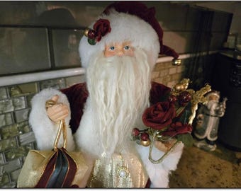 Vintage 17” Rosebud Standing Santa in a Burgundy Velvet Robe Bearing Gifts and a Gold Harp. 20 Dollars. OPDC-S006