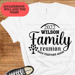 May include: White t-shirt with black text that reads "2022 WILSON Family reunion BACK TOGETHER AGAIN". The text is in a circle with a tree design at the bottom.