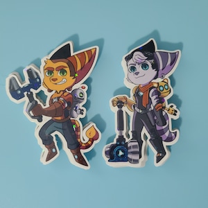 May include: Two cartoon character stickers, one orange and yellow with a blue weapon, the other gray and purple with a red scarf and a blue weapon.
