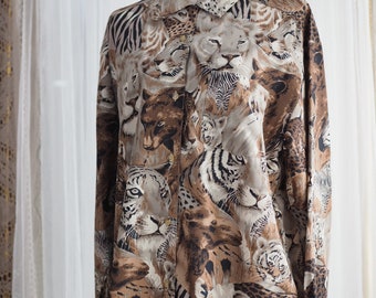 May include: A long-sleeved button-up shirt with a brown, beige and black animal print featuring tigers, zebras, leopards and other wildlife.