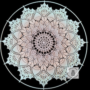 May include: A cream-colored, circular crochet doily with a detailed floral pattern. The doily is mounted within a white metal ring. The design features intricate lace-like details and a gradient of color from the center to the edges. The image is set against a black background.