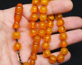 Amberkleurige bakelieten rozenkrans: islamitisch gebed met 33 kralen