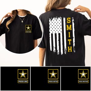 May include: Black t-shirts with military-themed designs. One shirt features a small gold star emblem with "PROUD MOM" text. Another displays a distressed American flag with the name "SMITH" in gold. Additional designs include "PROUD DAD", "PROUD SISTER", and "PROUD BROTHER".