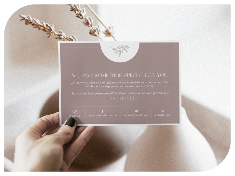 May include: A mauve-colored card with the text "WE HAVE SOMETHING SPECIAL FOR YOU!" and a floral design. The card includes a thank you message and a discount code. The card also displays social media handles and a website address.