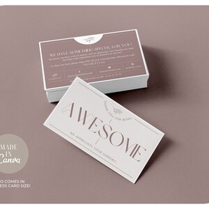 May include: A stack of business cards with a mauve background. One card reads "AWESOME" in large letters, with "THANK YOU FOR BEING" above. The other cards have text that reads "WE HAVE SOMETHING SPECIAL FOR YOU!" and "ALSO COMES IN BUISNESS CARD SIZE!"