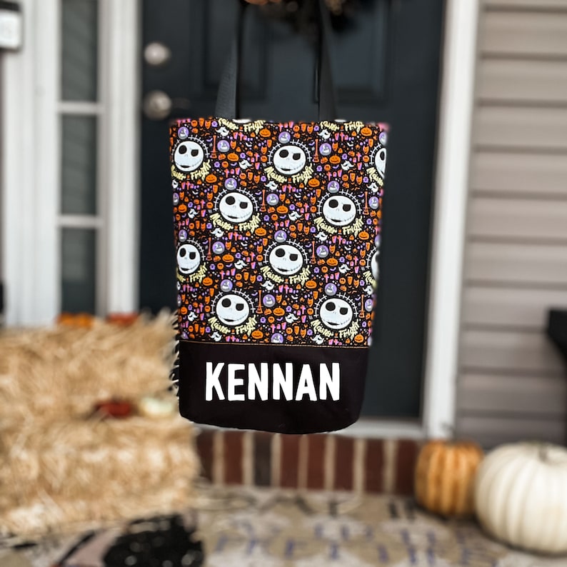 Halloween tote back featuring the face of Jack Skellington "Master of Fright" with a solid black base with a name in glow-in-the-dark heat transfer vinyl.