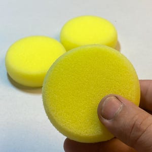 May include: Three yellow round foam sponges for polishing or cleaning.